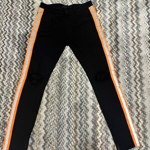 orange stripe on the side of the jeans